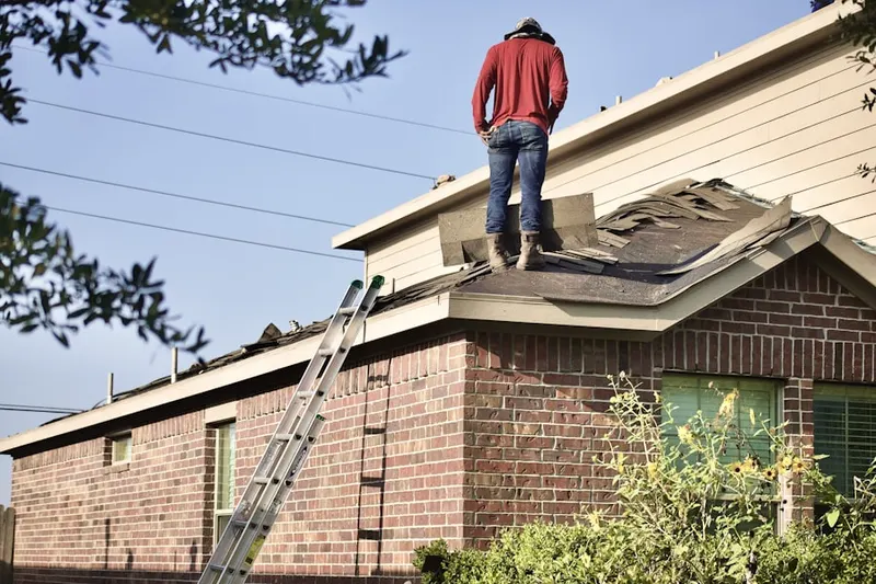 Professional roofer working on a residential roof in Mayfield